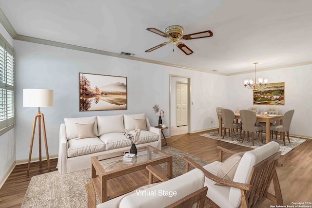 living room with ceiling fan with notable chandelier, ornamental molding, and dark hardwood / wood-style flooring