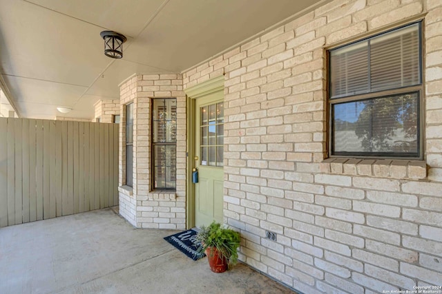 view of exterior entry featuring a patio