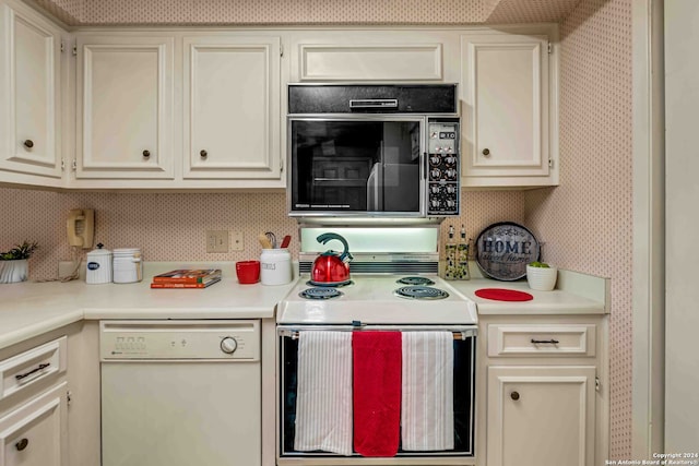 kitchen featuring white appliances and cream cabinetry