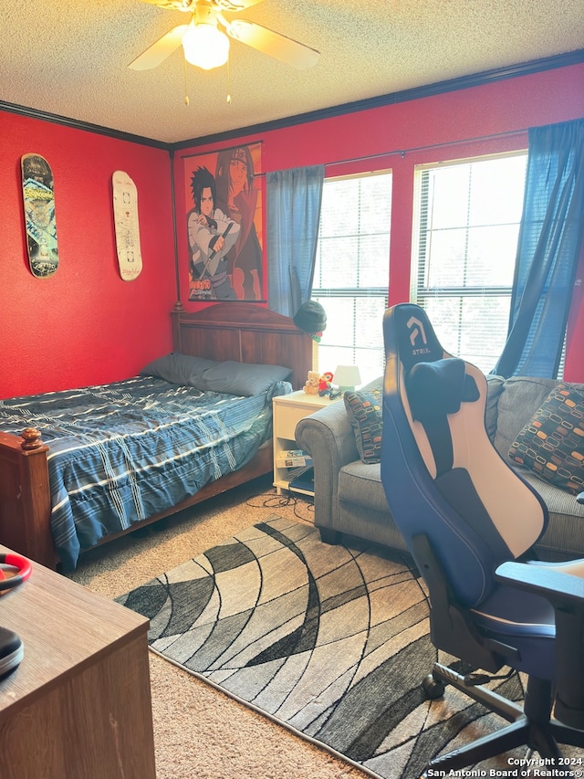 carpeted bedroom featuring ceiling fan and a textured ceiling