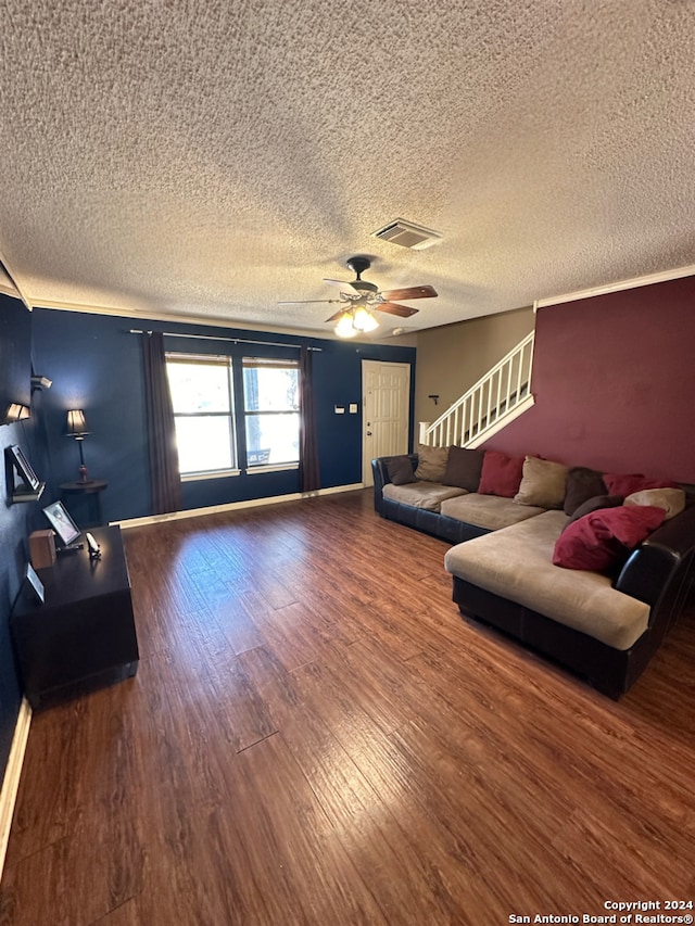 living room with a textured ceiling, wood-type flooring, and ceiling fan