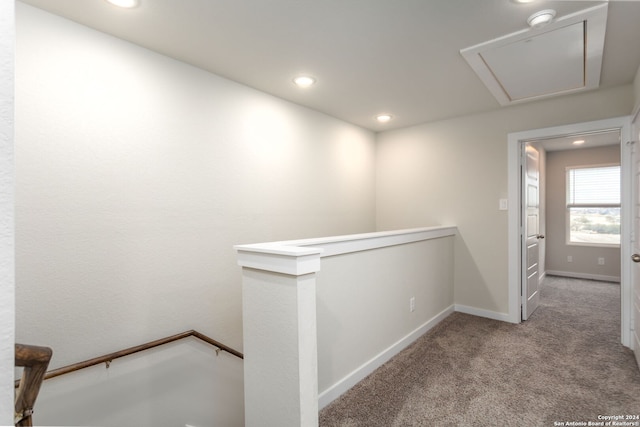 hallway featuring light colored carpet