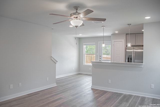 unfurnished living room featuring dark hardwood / wood-style floors and ceiling fan