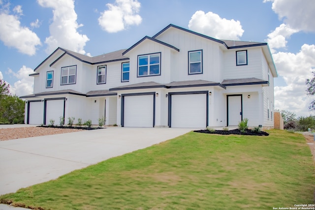 view of front of home featuring a front yard and a garage