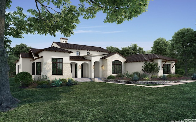 mediterranean / spanish house featuring a front yard, a standing seam roof, stone siding, and stucco siding
