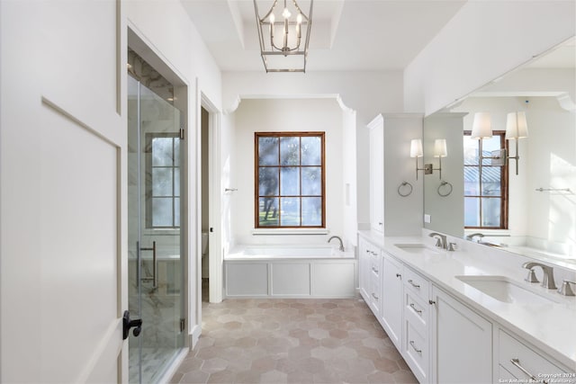 bathroom featuring a stall shower, a sink, and plenty of natural light