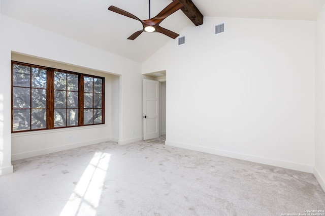 empty room featuring beam ceiling, visible vents, a ceiling fan, and carpet