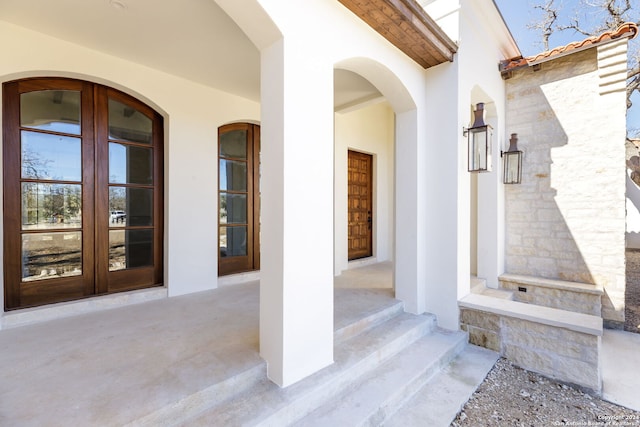 entrance to property with stucco siding and french doors