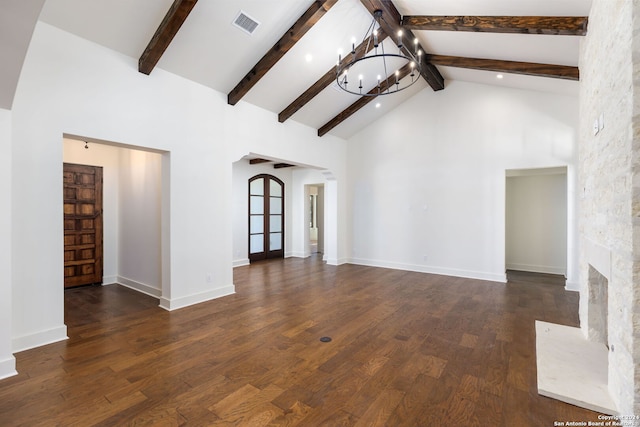 unfurnished living room featuring visible vents, wood finished floors, beam ceiling, high vaulted ceiling, and a notable chandelier