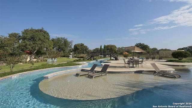 community pool featuring a patio area and stairs