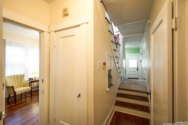 corridor with dark hardwood / wood-style flooring