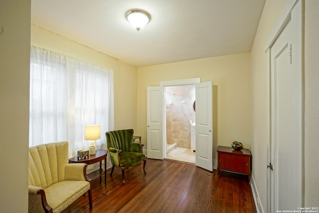 sitting room with a healthy amount of sunlight and dark hardwood / wood-style floors