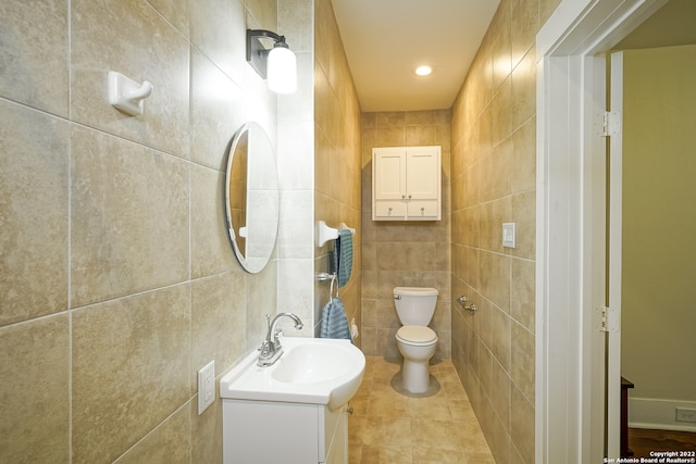 bathroom featuring tile walls, tile patterned flooring, vanity, and toilet