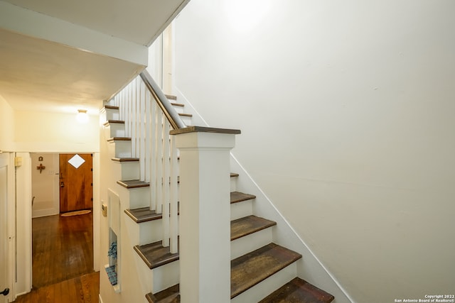 staircase with hardwood / wood-style floors