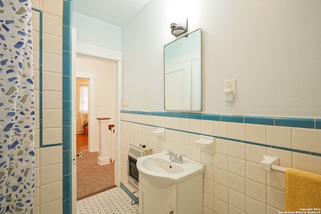 bathroom with tile walls, vanity, a shower with shower curtain, and heating unit