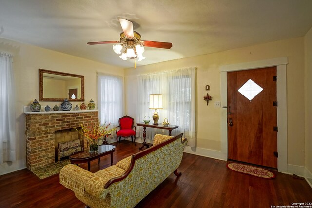 interior space featuring ceiling fan, dark hardwood / wood-style floors, and a fireplace