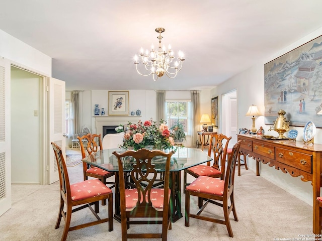 dining area with light colored carpet and an inviting chandelier