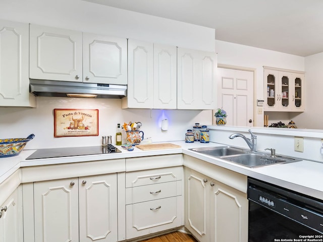 kitchen with white cabinets, light hardwood / wood-style floors, sink, and black appliances