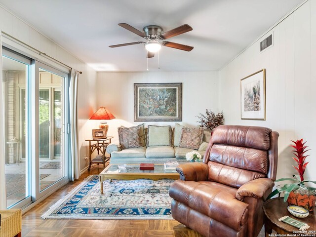 living room with ceiling fan and parquet flooring