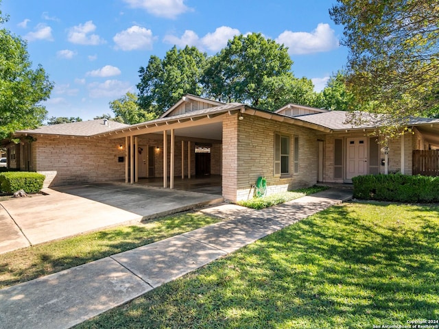 ranch-style house with a carport and a front yard