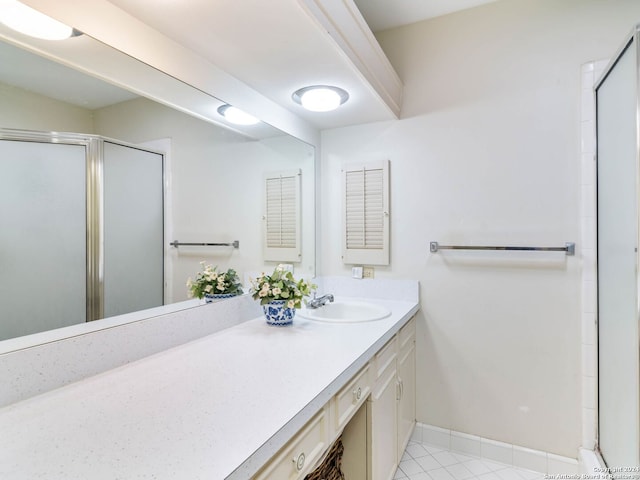 bathroom with vanity, tile patterned floors, and a shower with door