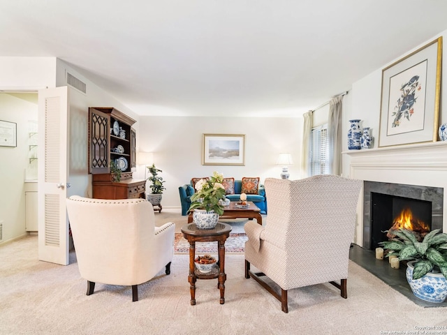 carpeted living room featuring a fireplace