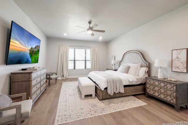 bedroom with light wood-type flooring and ceiling fan