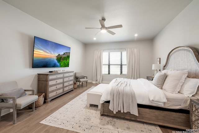 bedroom with ceiling fan and light hardwood / wood-style flooring