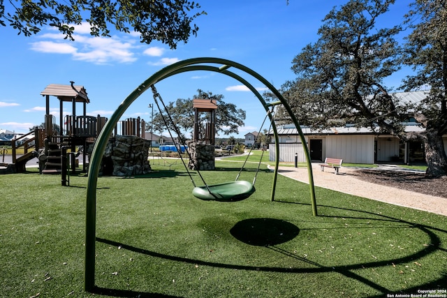 view of community featuring a playground and a lawn