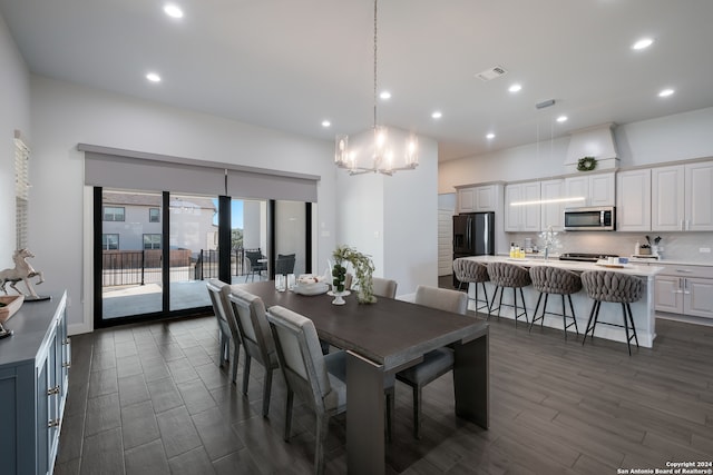 dining space with a notable chandelier and dark wood-type flooring