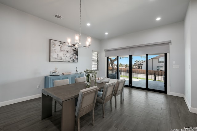 dining space with a chandelier and dark wood-type flooring