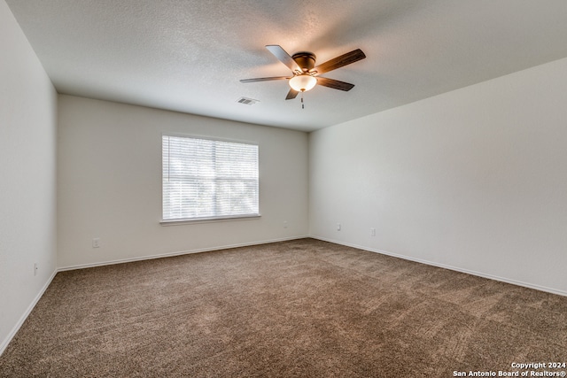 carpeted empty room with a textured ceiling and ceiling fan