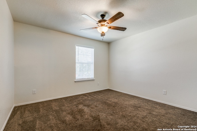 carpeted empty room with a textured ceiling and ceiling fan