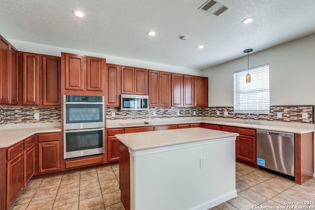 kitchen featuring backsplash, stainless steel appliances, and hanging light fixtures