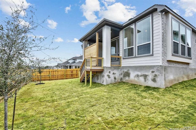 view of side of home featuring a yard