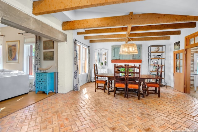 dining space featuring vaulted ceiling with beams and light hardwood / wood-style floors