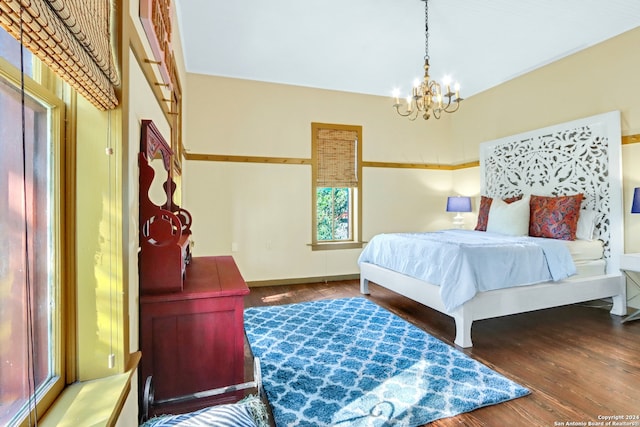 bedroom with a notable chandelier and hardwood / wood-style floors