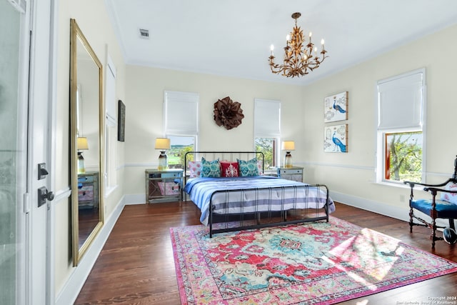 bedroom with ornamental molding, a notable chandelier, and dark hardwood / wood-style flooring