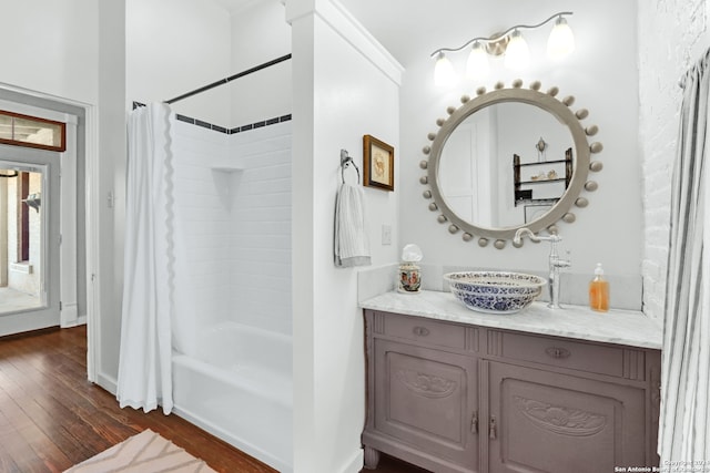 bathroom with wood-type flooring, shower / bath combo, and vanity