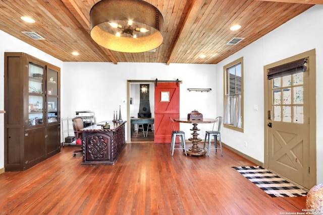 foyer featuring wood ceiling, dark hardwood / wood-style flooring, and a barn door