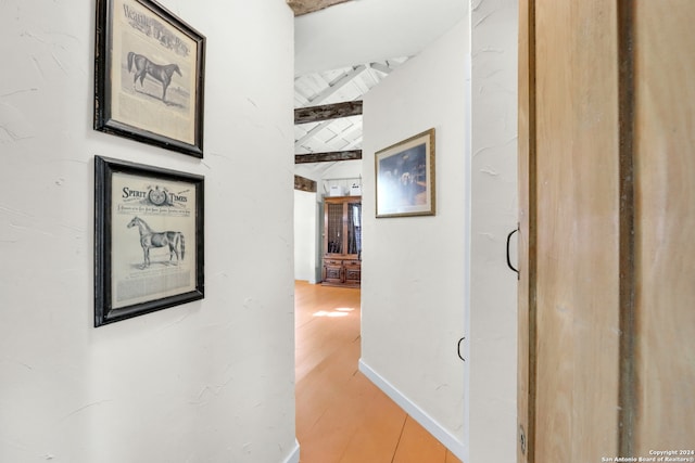 hall featuring beam ceiling and hardwood / wood-style floors