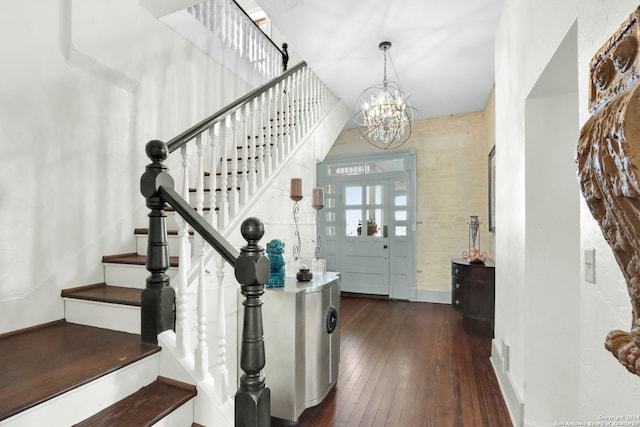 foyer with an inviting chandelier and dark hardwood / wood-style flooring