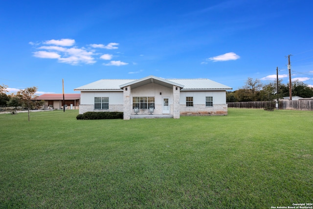 rear view of house with a lawn