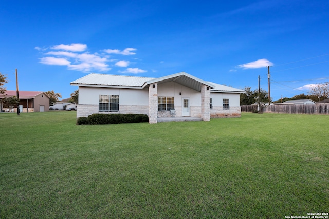 rear view of property with a lawn