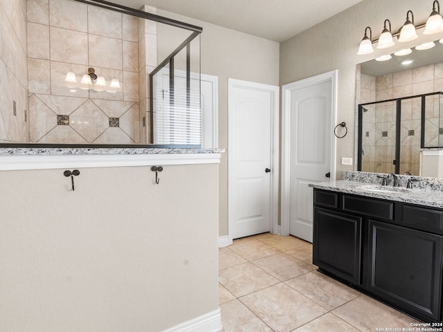 bathroom with vanity, a shower with door, and tile patterned floors