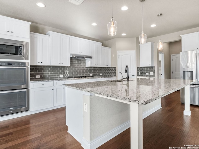 kitchen featuring pendant lighting, dark wood-type flooring, sink, white cabinetry, and appliances with stainless steel finishes