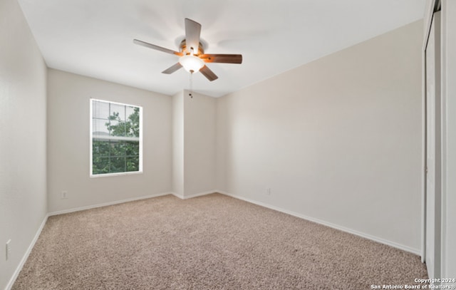 carpeted empty room with ceiling fan