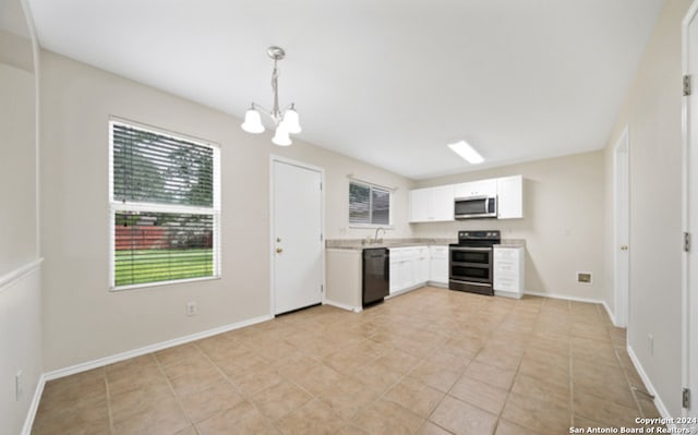 kitchen featuring hanging light fixtures, sink, white cabinetry, stainless steel appliances, and an inviting chandelier