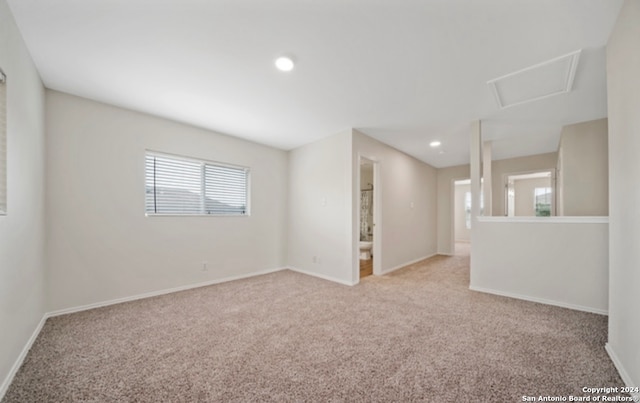 unfurnished room featuring light colored carpet