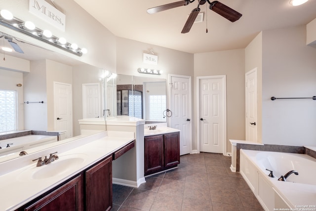 bathroom featuring ceiling fan, vanity, a washtub, and tile patterned floors